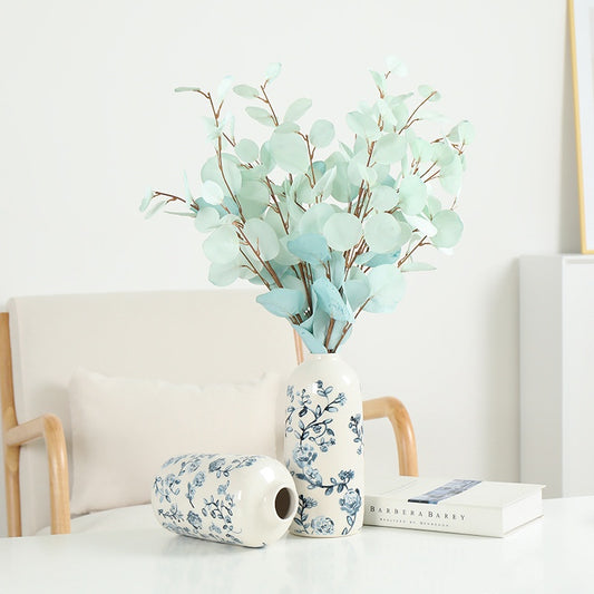 Decorative vase with blue floral patterns on a white surface with a light background