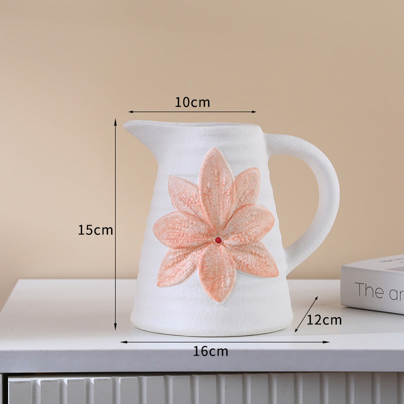 White ceramic pitcher with a pink flower design, shown with measurements on a beige background.