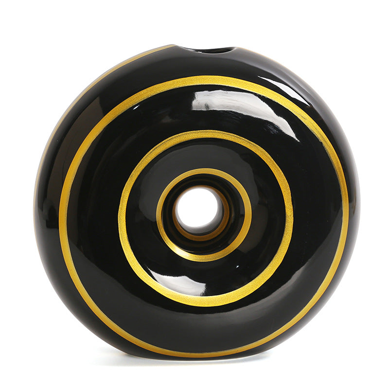 Black wheel with gold rim on a white background