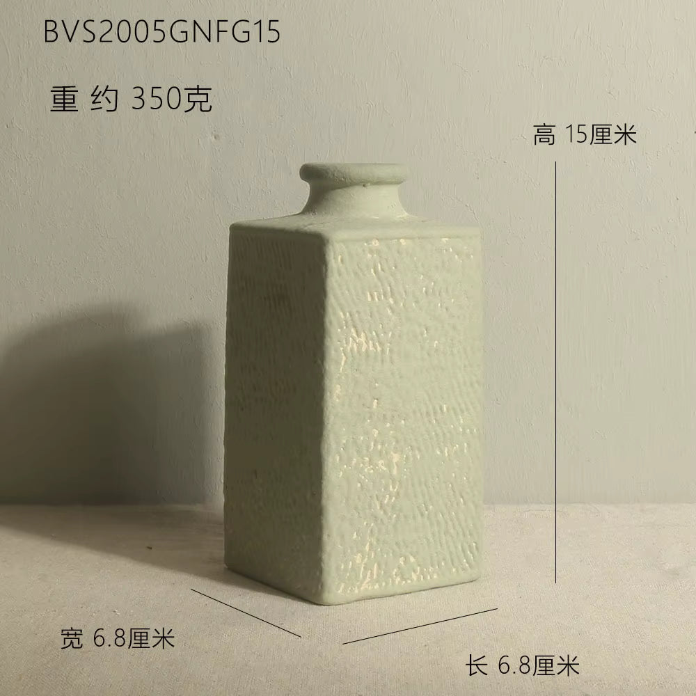 Green ceramic square bottle with dimensions on a neutral background