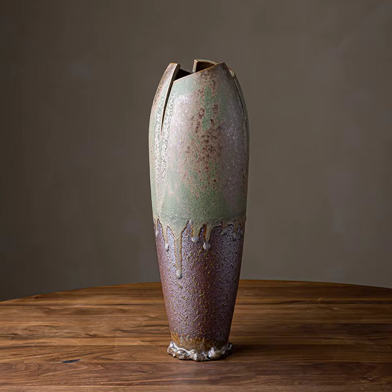 Rustic ceramic vase on a wooden surface with a dark background