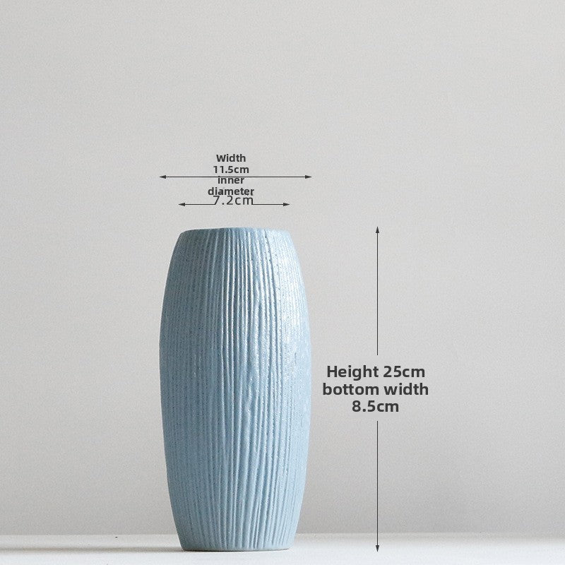 Blue textured vase with measurements on a light gray background