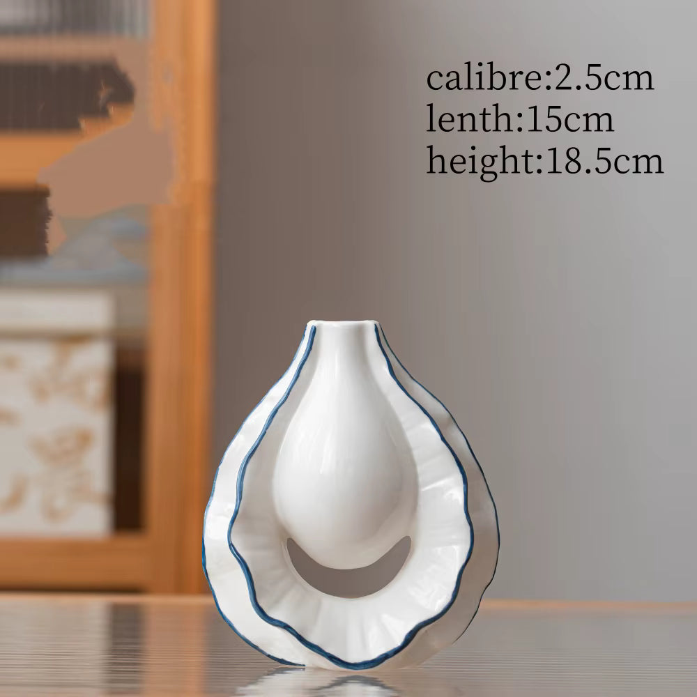 White ceramic vase with blue rim on a wooden surface, measurements displayed.