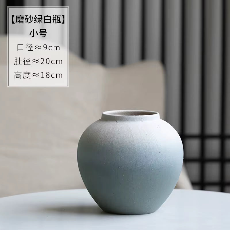 Gray ceramic vase on a table with text overlay