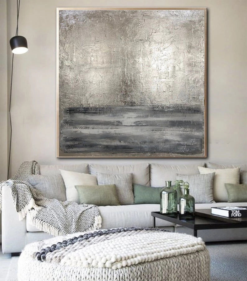 Living room with a large abstract painting on the wall above a sofa.