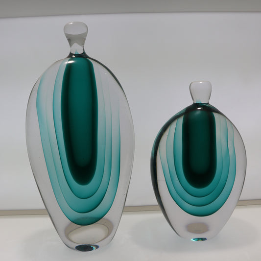 Two glass vases with concentric color bands on a white background