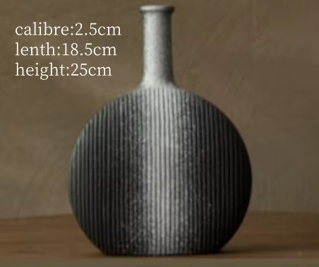 Textured vase on a wooden surface with measurements displayed