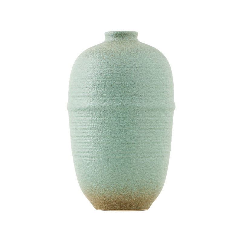 Textured green vase on a white background