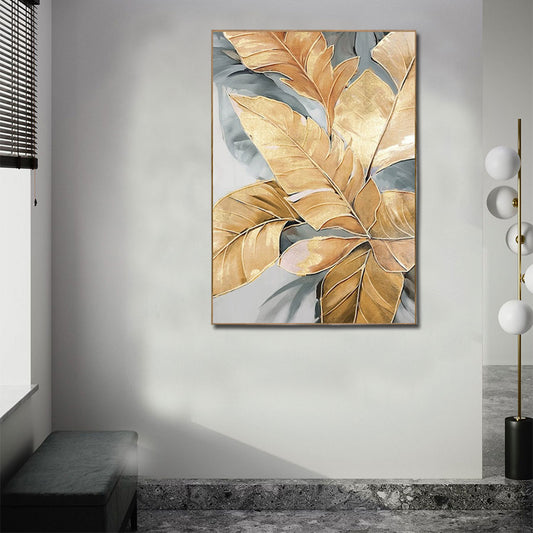 Abstract art piece with gold and gray leaves on a wall in a modern room.