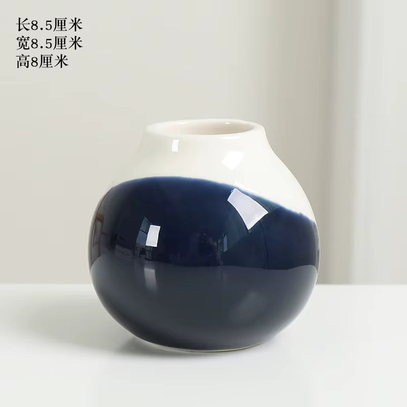 Ceramic vase with blue and white gradient on a light background