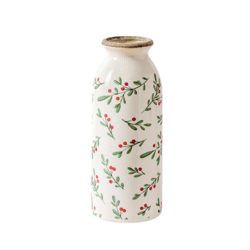 Decorative vase with holly berry pattern on a white background