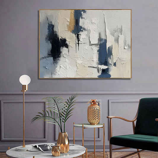 Modern living room with abstract painting, green chair, and decorative items.