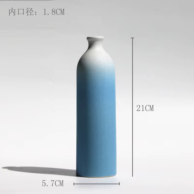 Blue and white ceramic vase with measurements on a white background