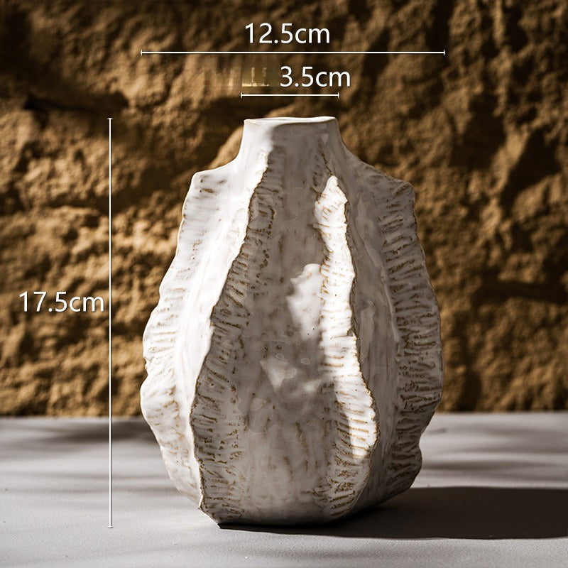 Decorative vase with measurements against a textured wall background