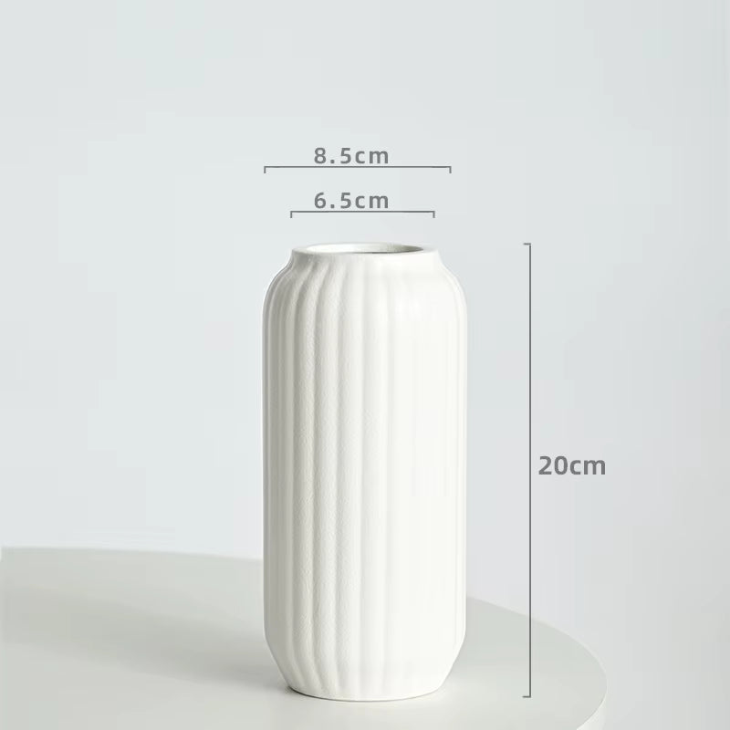 White vase with dimensions on a light gray background