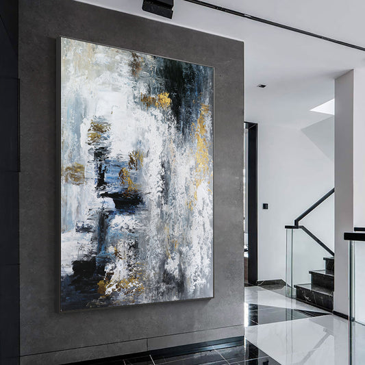 Abstract painting in a modern interior setting with a staircase.