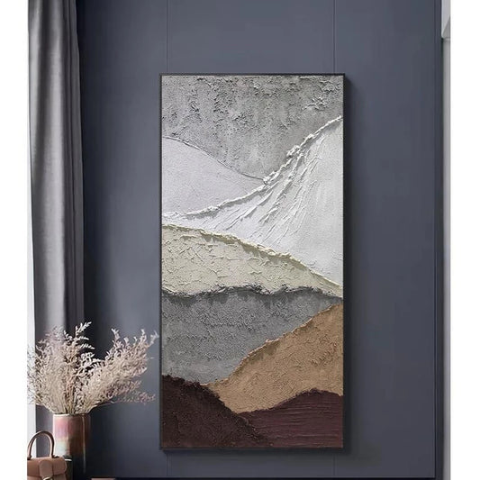 Abstract art painting on a dark gray wall with a plant and bag in the foreground.