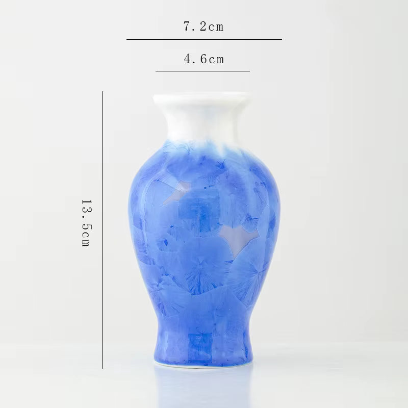 Blue ceramic vase with measurements on a white background