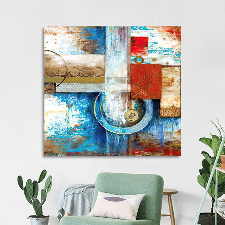 Abstract art painting on a wall in a living room with a green chair and plants.