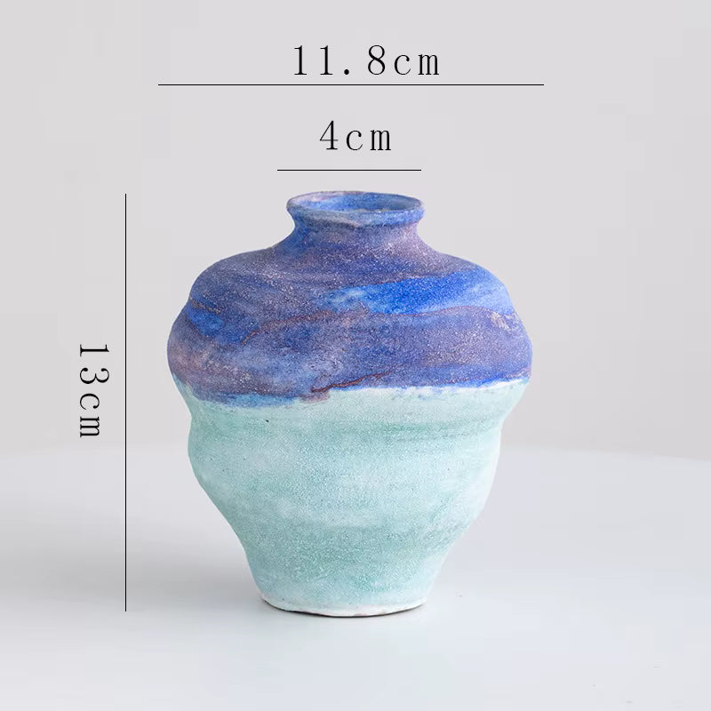 Ceramic vase with blue and green gradient on a light gray background, showing measurements.