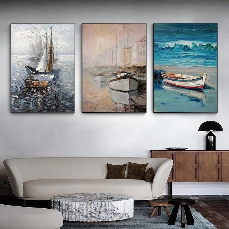Three abstract paintings of boats on a wall above a sofa in a living room.