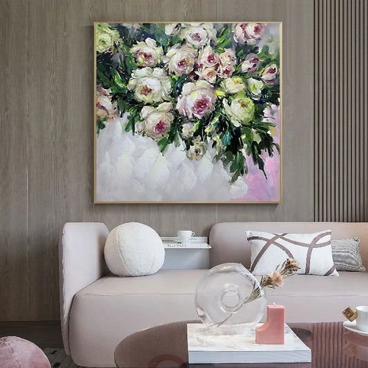 Floral painting on a wall above a sofa in a living room setting