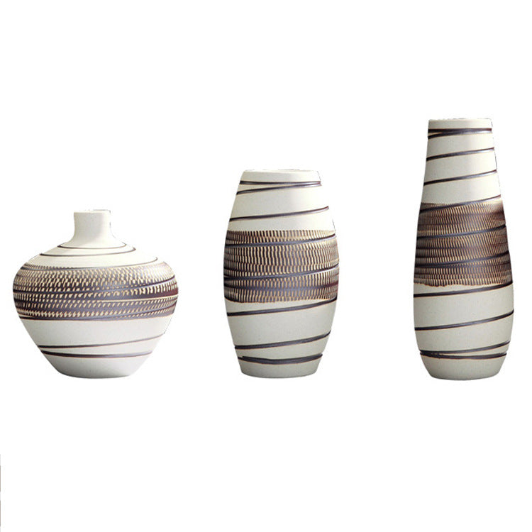 Three decorative vases with striped patterns on a white background