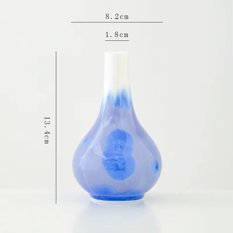 Blue glass vase with measurements on a white background