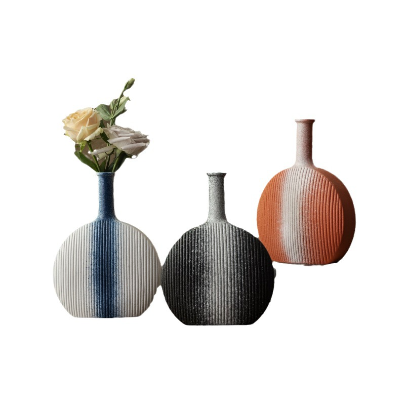 Three decorative vases with striped patterns on a white background
