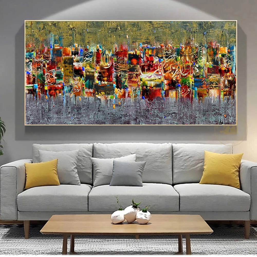 Abstract painting on a wall above a gray sofa with yellow and gray cushions.
