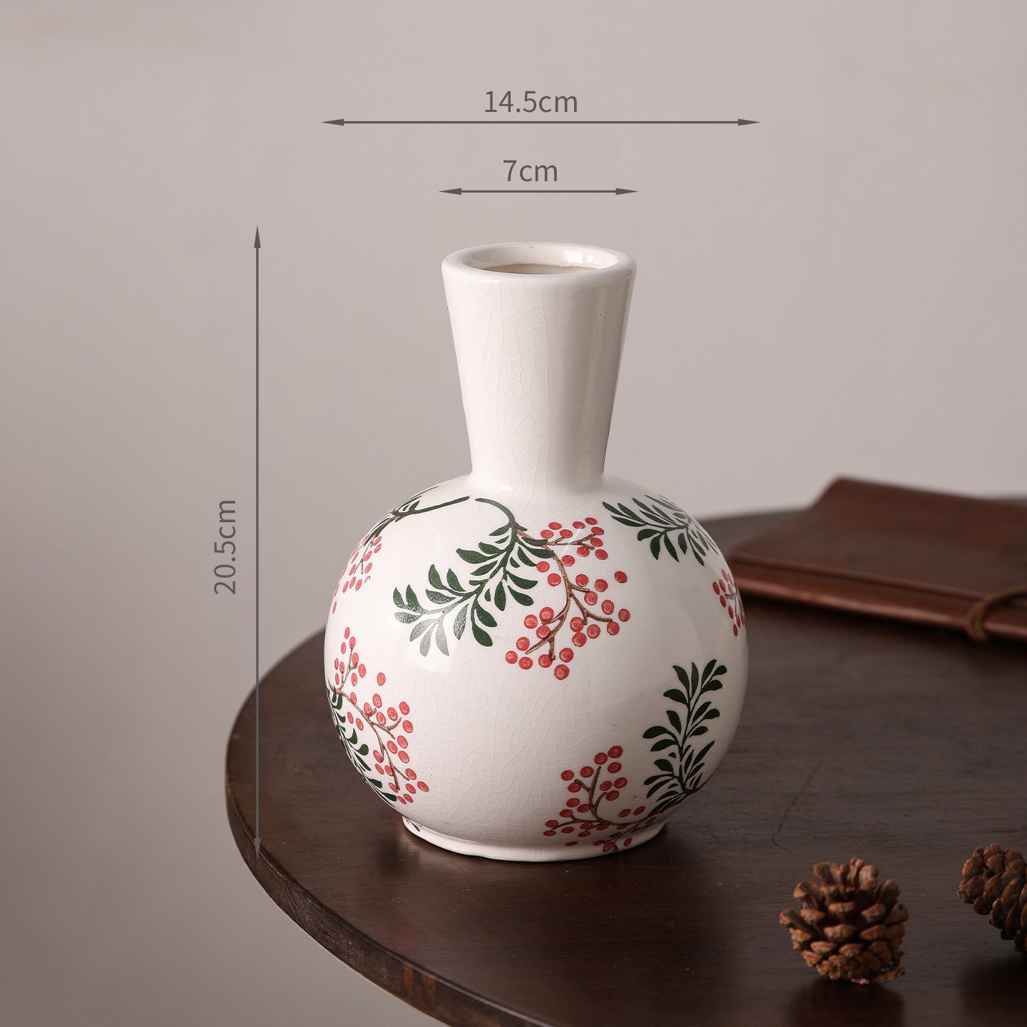 White vase with floral design on a wooden surface, with measurements indicated.