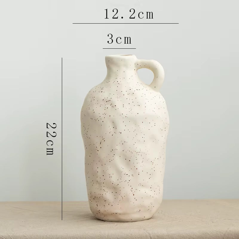 Speckled ceramic vase on a neutral background with measurements indicated.