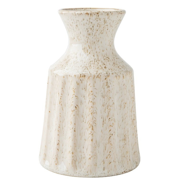 White ceramic vase with a textured surface on a white background