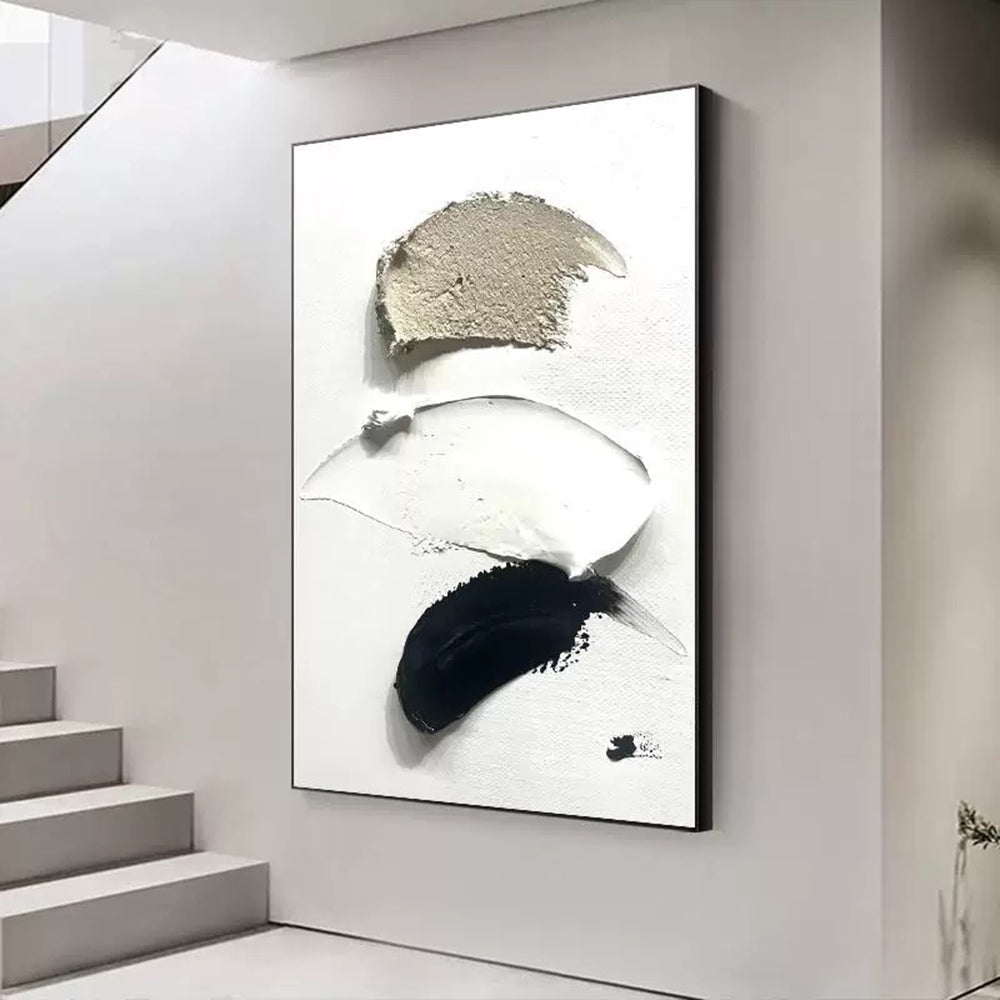 Abstract art piece with black and white brush strokes on a wall in a modern interior setting.