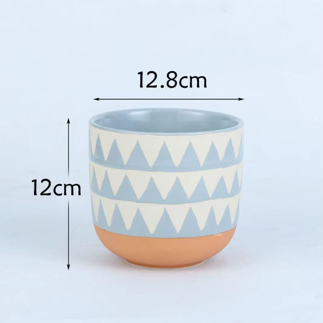 Ceramic cup with geometric pattern and measurements on a light blue background