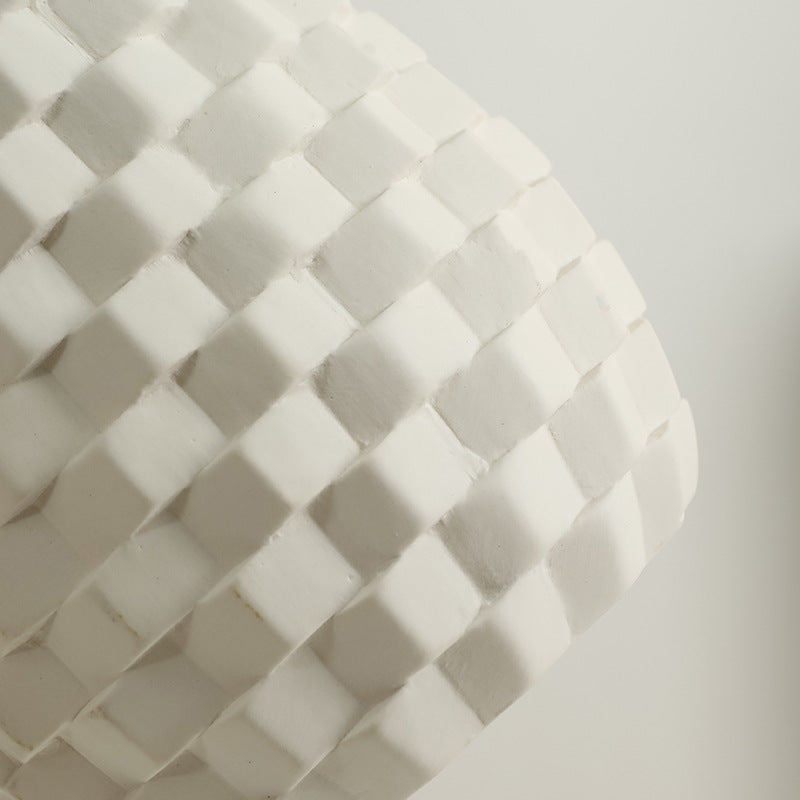 Close-up of a textured white surface with a geometric pattern