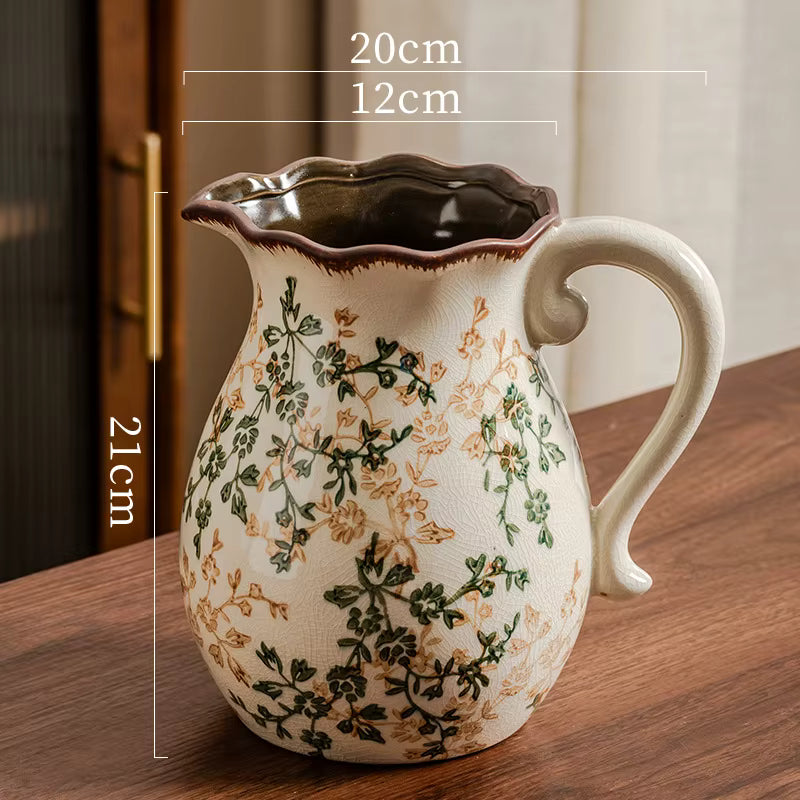 Decorative ceramic pitcher with floral patterns on a wooden surface, showing measurements.