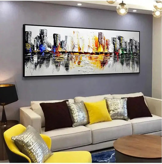 Colorful abstract cityscape painting on a wall above a sofa with decorative pillows.