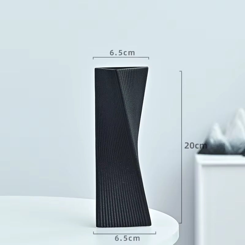 Black textured vase with dimensions on a light gray background