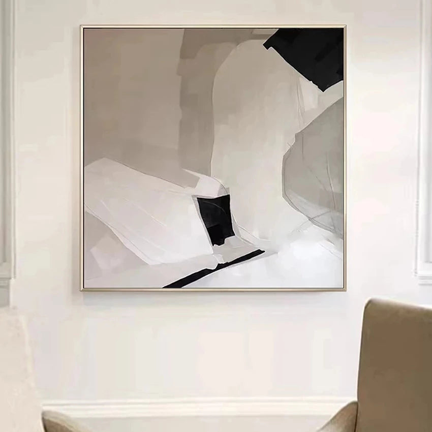 Abstract art piece in a modern interior setting with a chair and table.