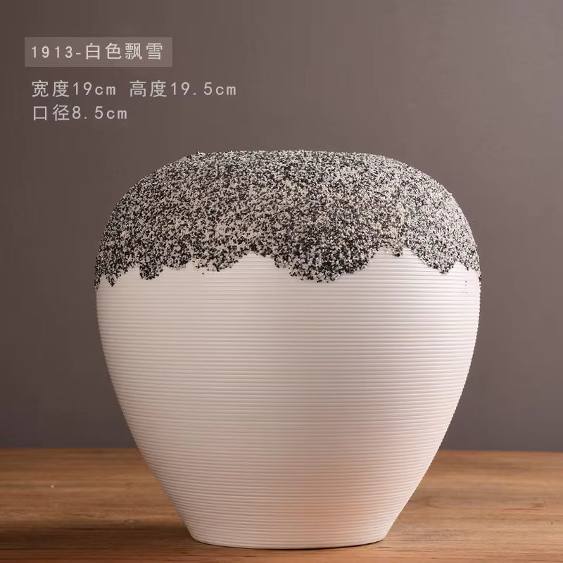 White vase with textured top on a wooden surface and brown background