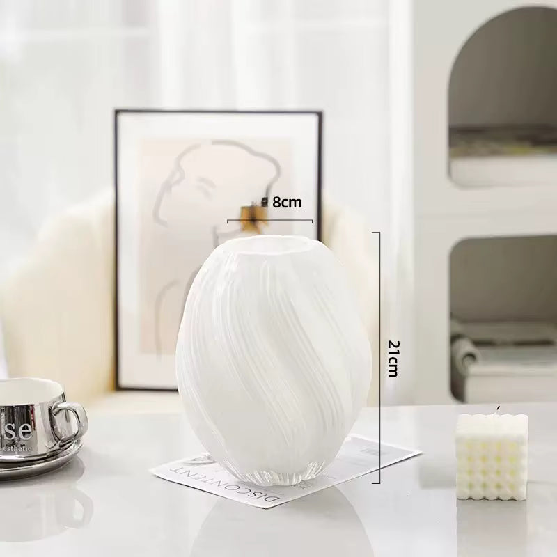 White marble-patterned vase on a table with measurements indicated