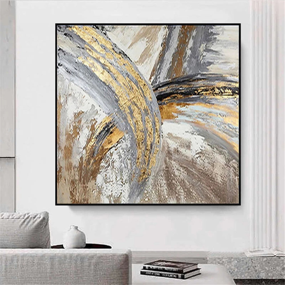 Abstract art painting with gold and gray tones in a modern living room setting.