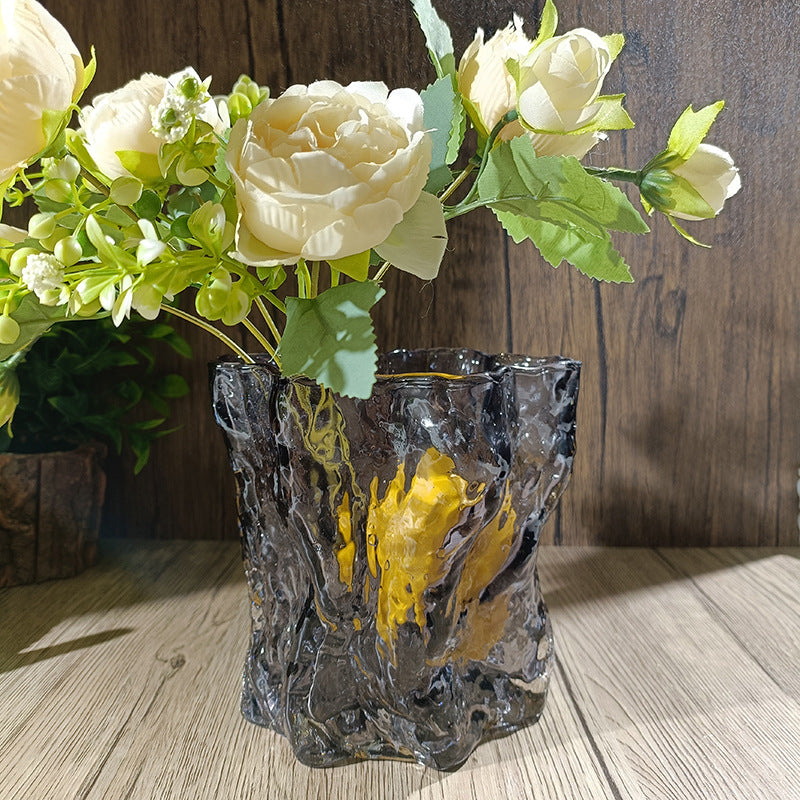 Decorative vase with floral arrangement on a wooden surface