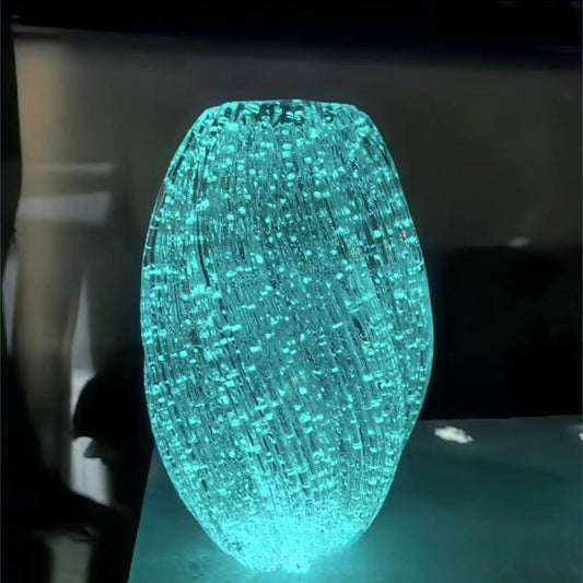 Glowing blue fiber optic light on a dark background