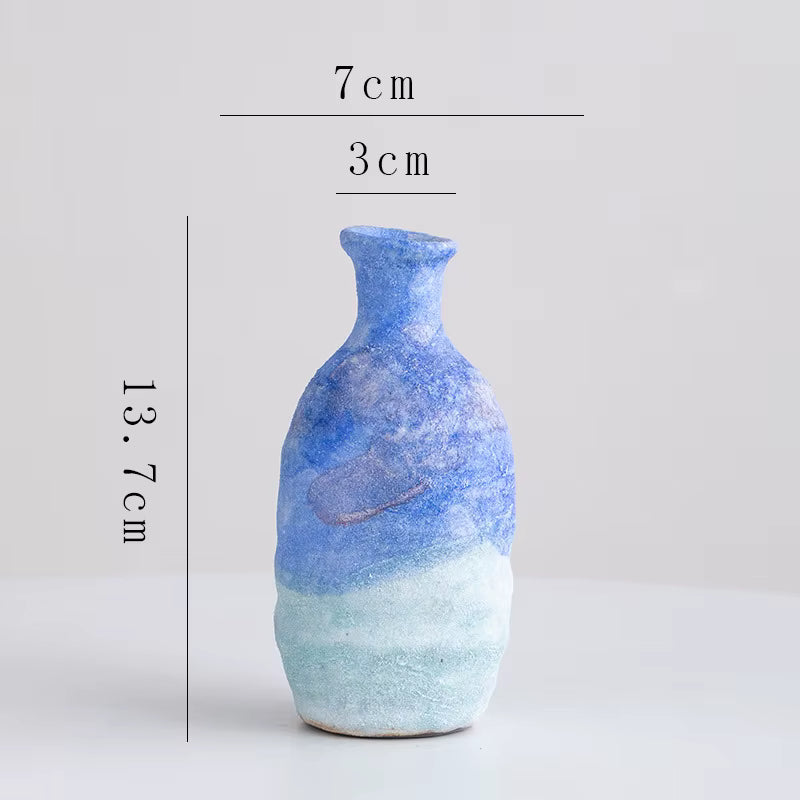 Blue ceramic vase with measurements on a white background