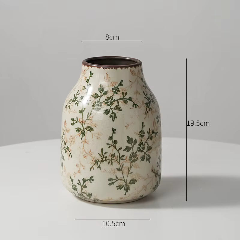Ceramic vase with floral patterns and measurements on a gray background