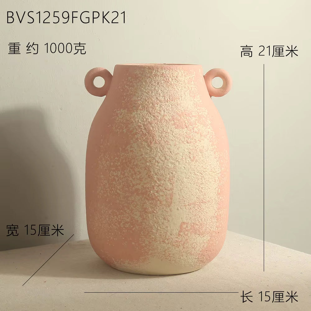 Pink textured vase with handles on a light background