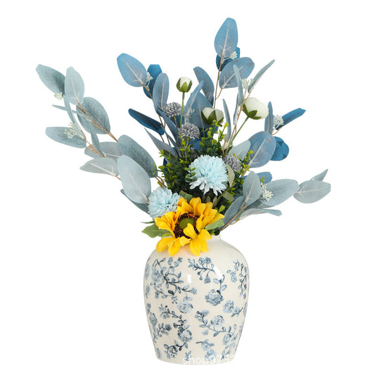 Floral arrangement in a decorative vase on a white background