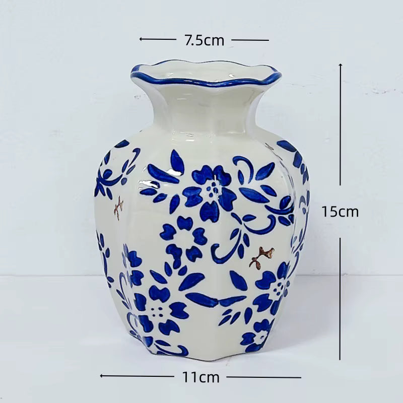 Ceramic vase with blue floral patterns and measurements on a white background